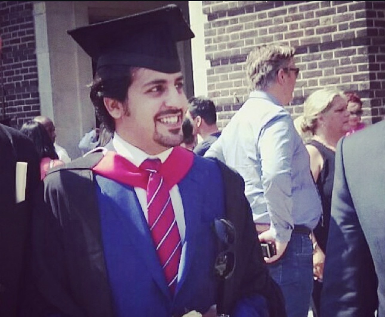 A graduation portrait of Abdulaziz Alfuraih in academic attire