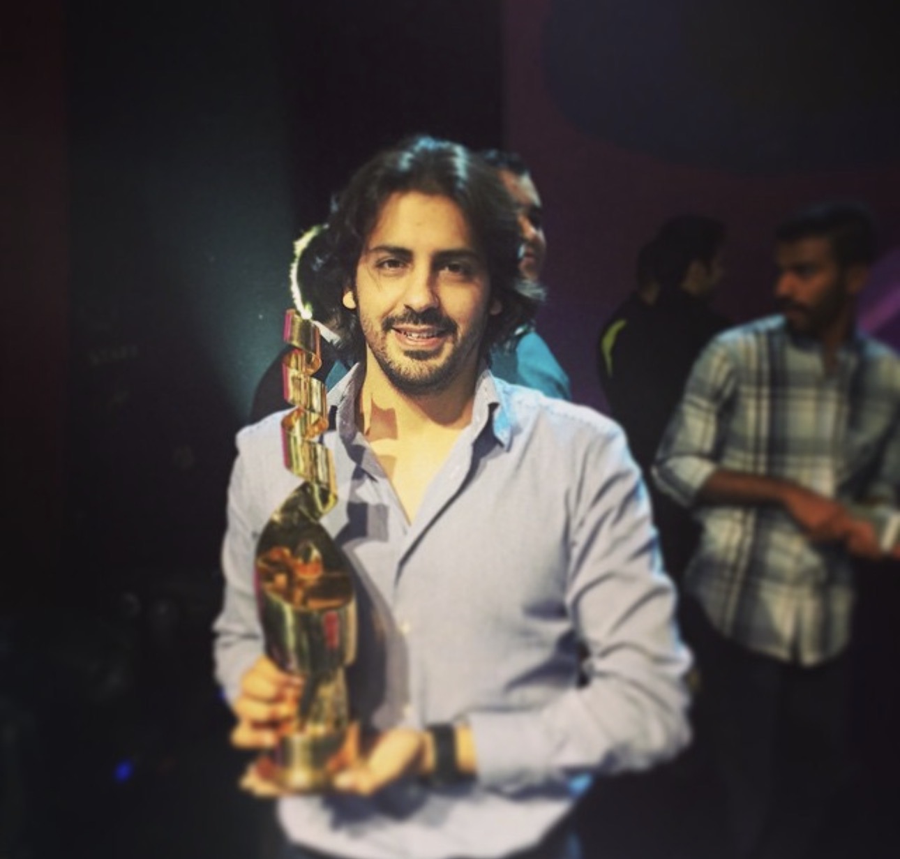 Abdulaziz Alfuraih holding an award at a recognition ceremony