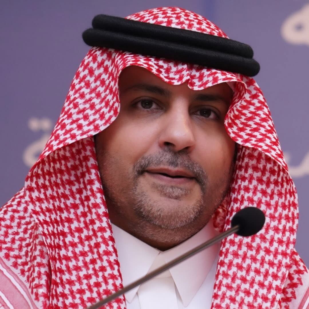 A close-up portrait of Abdulaziz Alfuraih speaking at a microphone