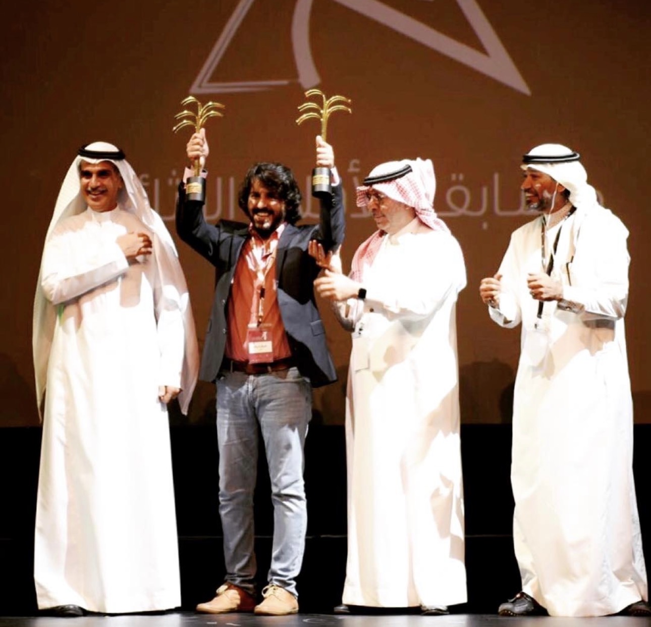 Abdulaziz Alfuraih celebrating the awards for Building 20 on stage
